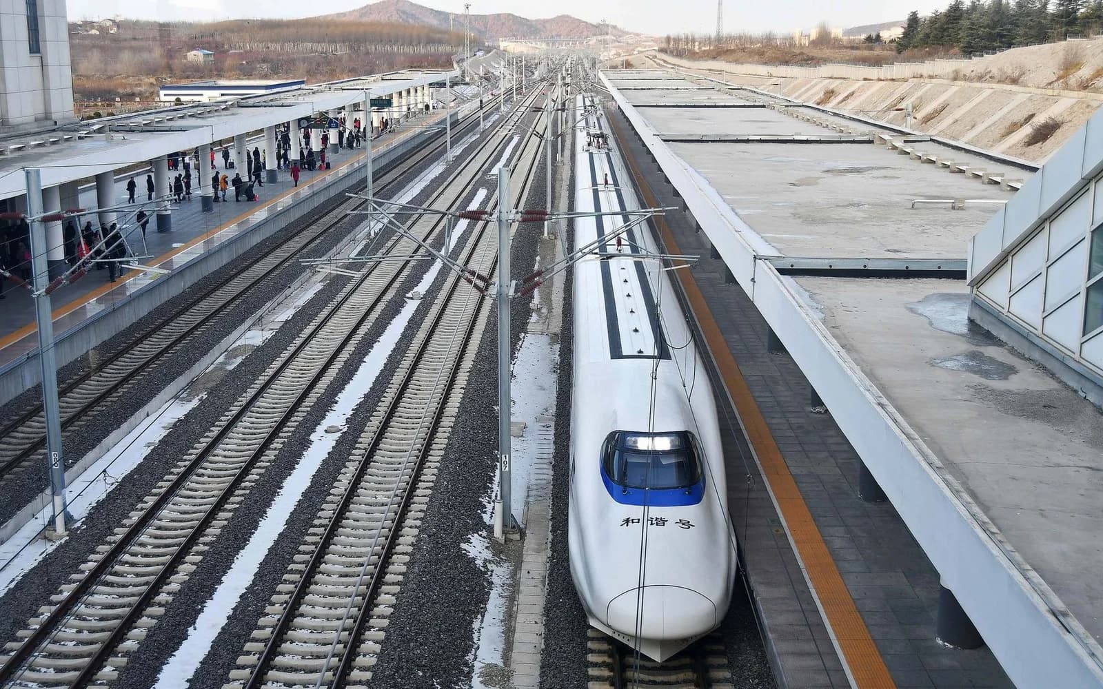 A high-speed train standing beside the platform at a railway station