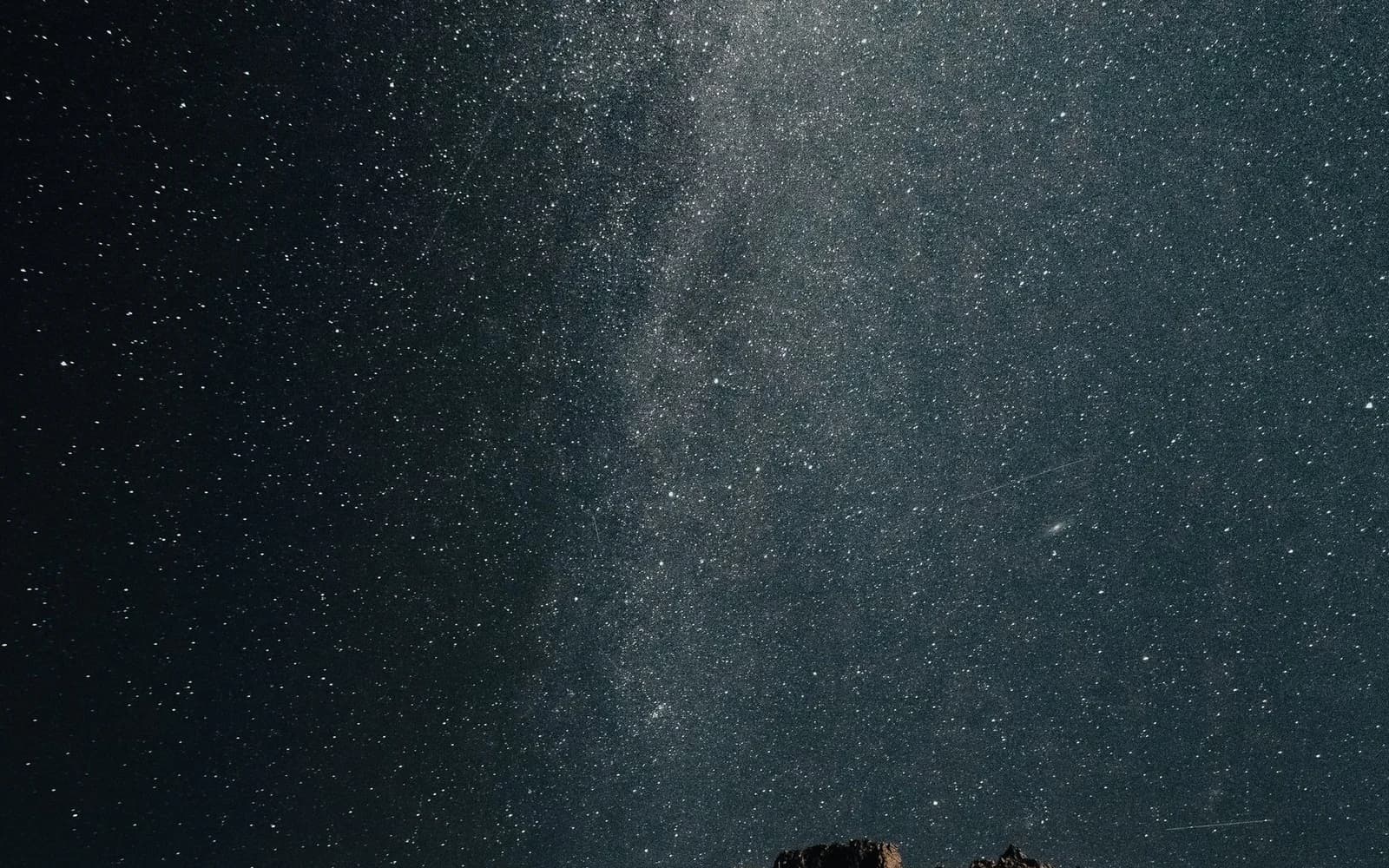 Cielo estrellado con una banda de la Vía Láctea sobre un horizonte oscuro; fotografía ilustrativa, no observaciones de las Oriónidas de octubre de 2026.