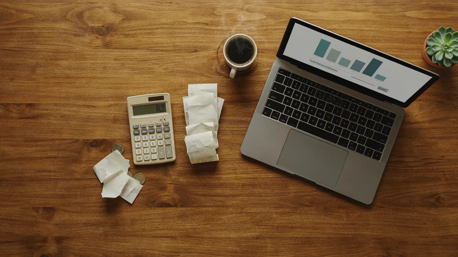 A small business desk from above: a calculator, receipts, a laptop with simple bar charts and a cup of coffee; AI-generated illustration