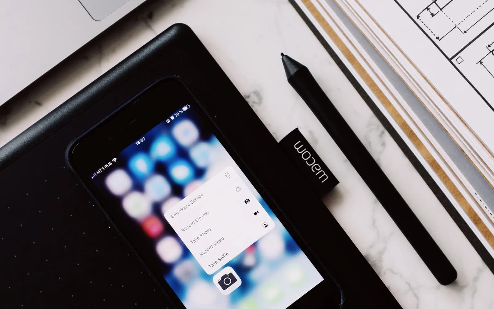 Editorial photograph: Pop up window on smartphone screen and book with drawing