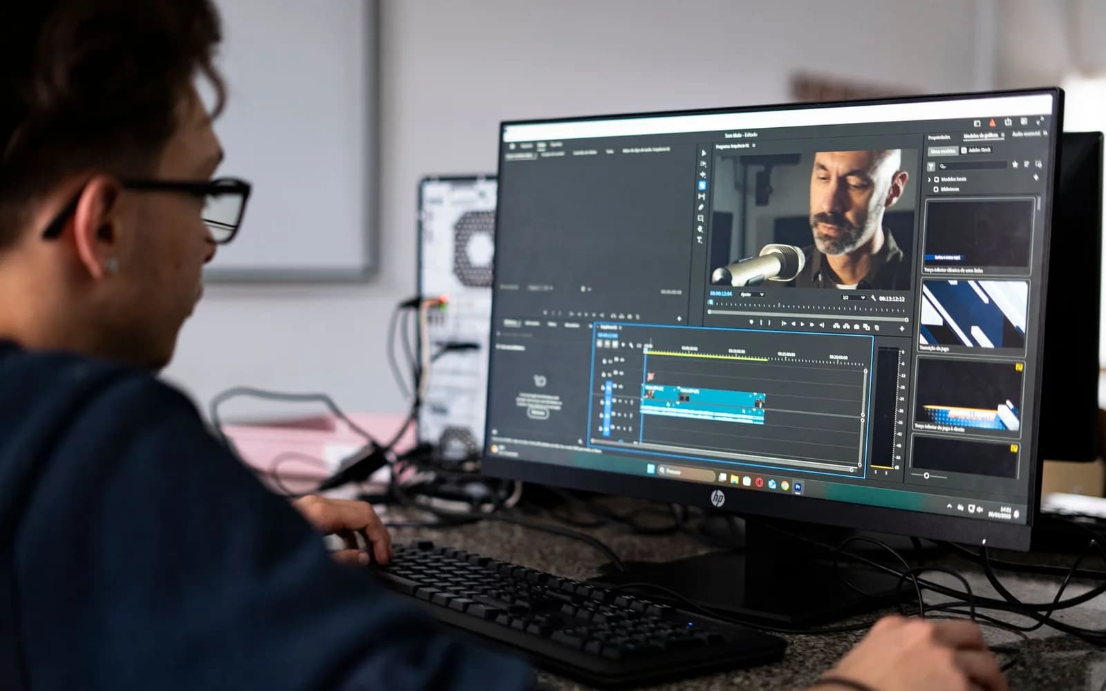 Editorial photograph: Video Editor Working on Desktop Computer in Office