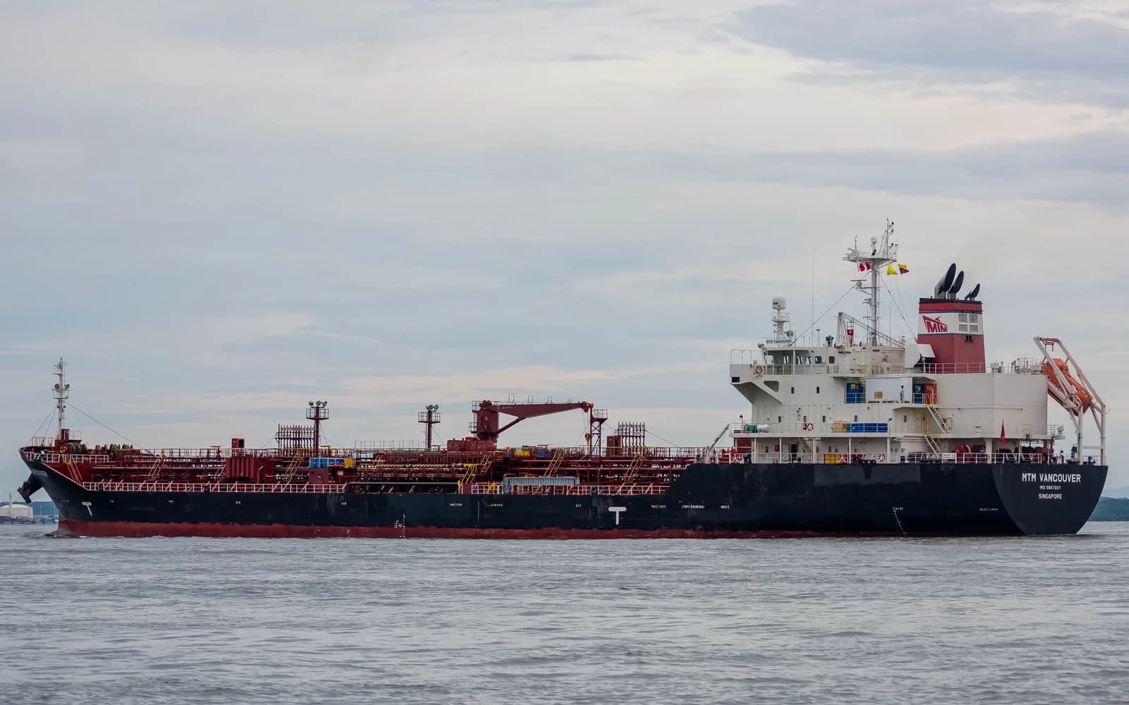 An oil tanker on the sea beneath a cloudy sky; an illustrative photograph, not documentation of current conditions in the Strait of Hormuz.