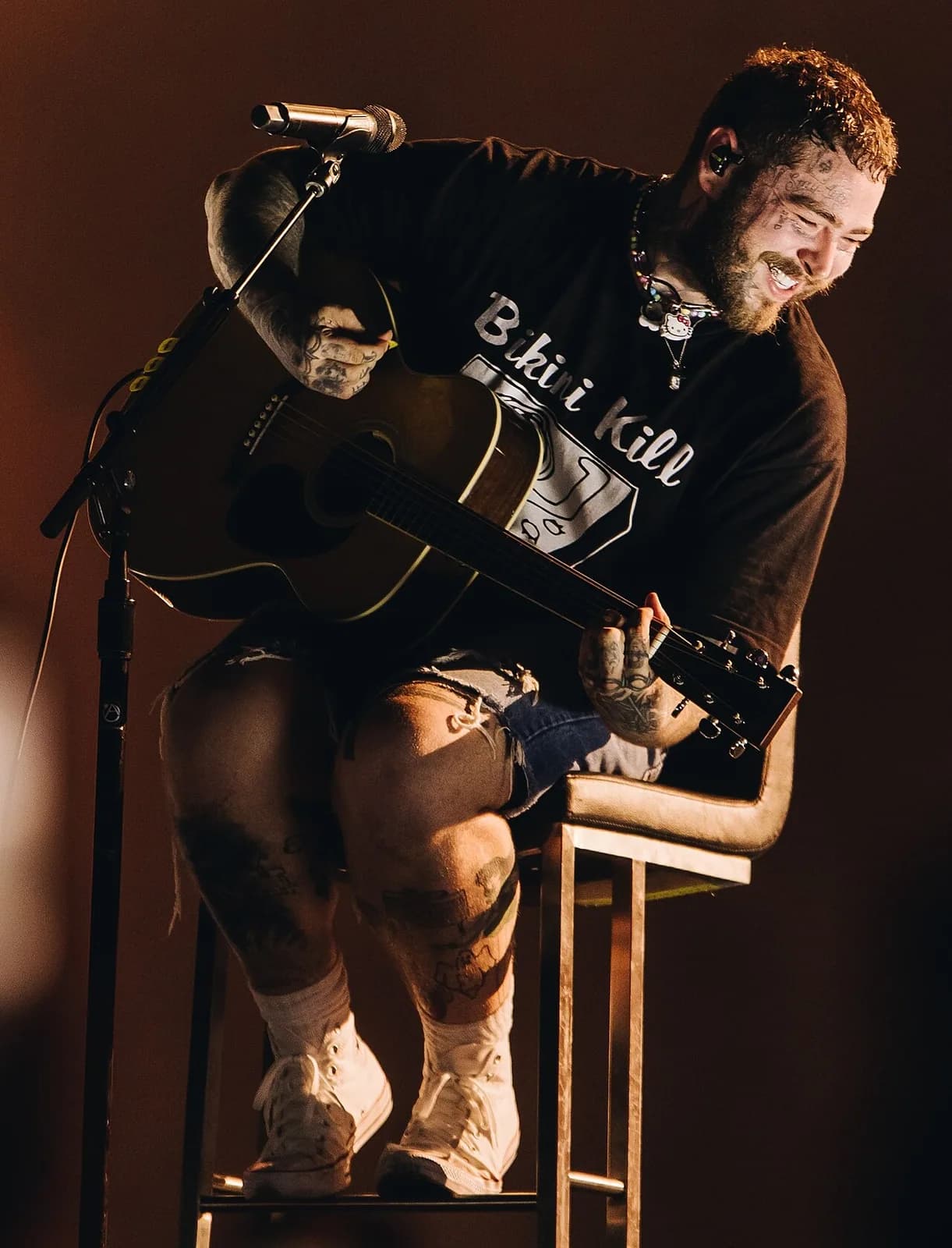 Post Malone performing with an acoustic guitar
